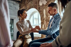 a person holds another's hands after asking "what is aftercare for addiction recovery?"