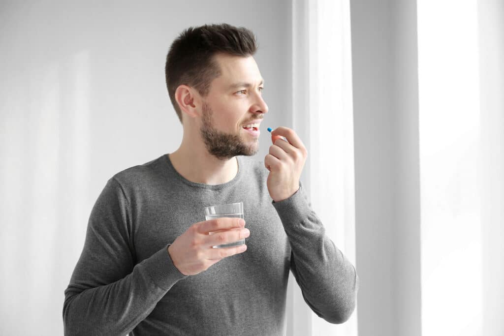 a person takes a pill before understanding the dangers of self-medicating