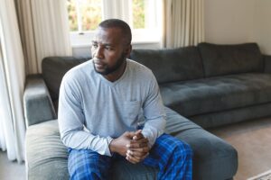 a person sits on a couch thinking about the effects of drunk driving