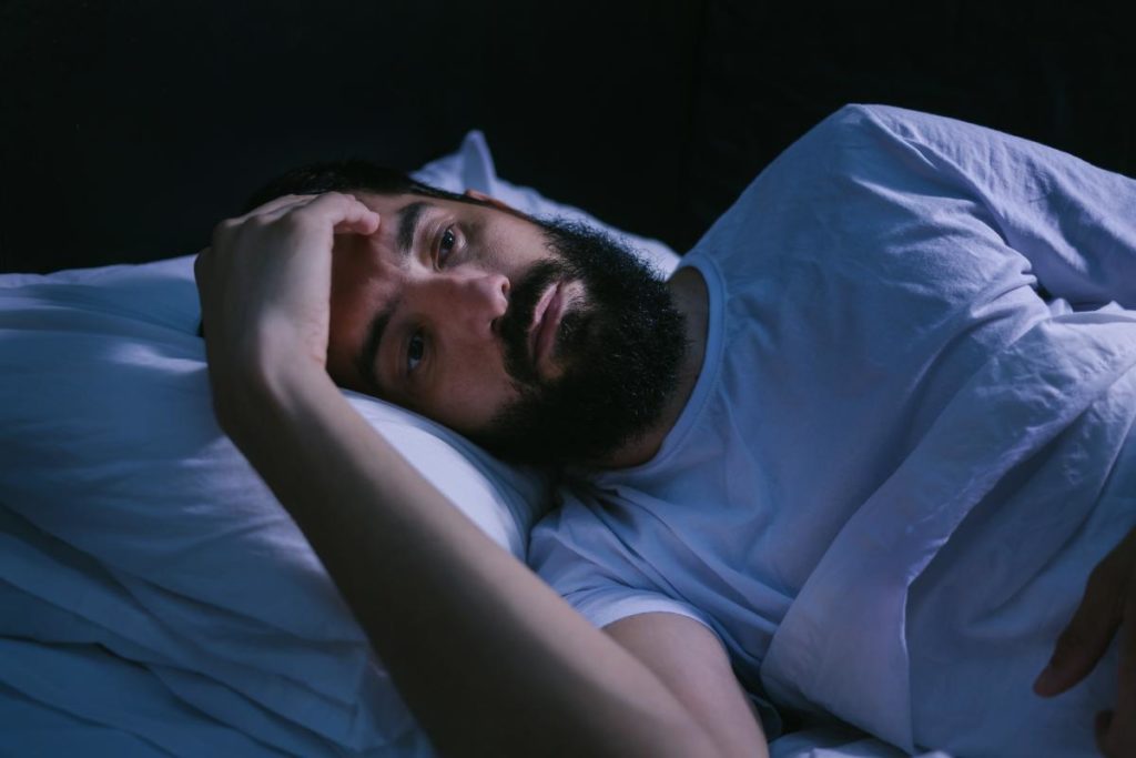 a person laying in bed Can't sleep sober