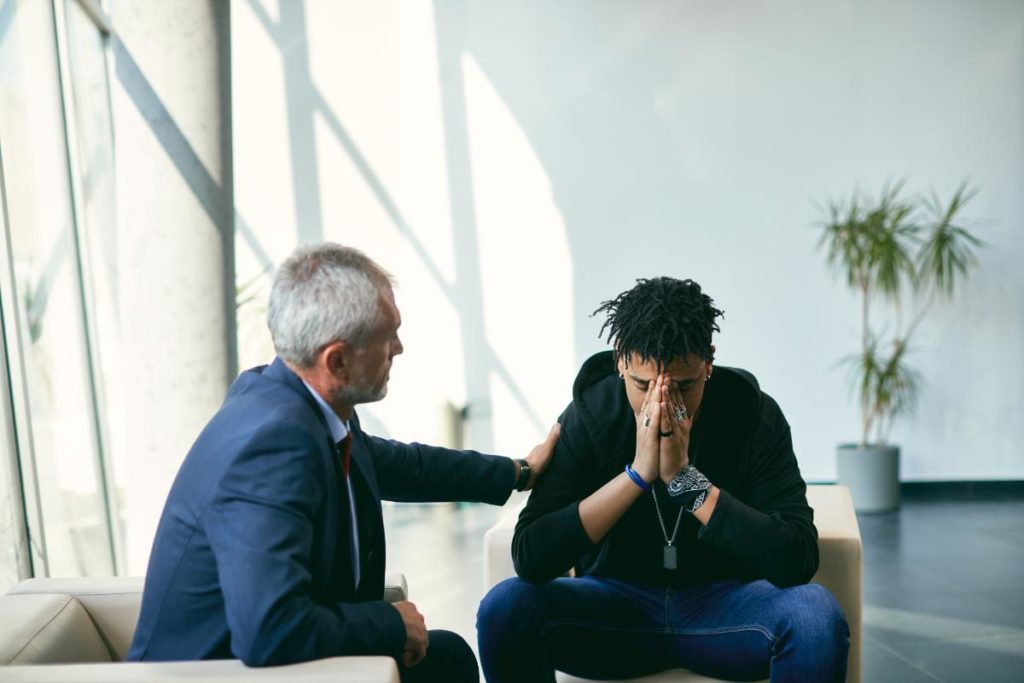 a person comforts another as they learn How to sober up from being crossfaded