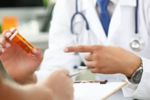 a doctor points at a bottle of pills to explain the Street name for clonazepam