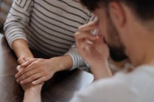 two people hold hands one of the ways that is effective in Supporting someone with depression