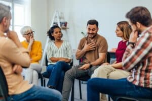 a group listens while a member asks "how do i pay for rehab?"