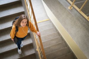a student walks down a stairwell while dealing with adderall abuse in college students