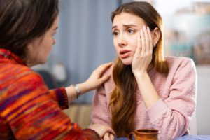 a mother comforts a child over the signs of codeine abuse