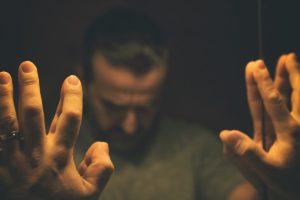 a person experiencing the side effects of percocet braces against a mirror