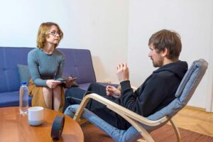 a person talks to a therapist in a vicodin addiction treatment program
