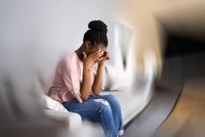 a person sits in a spinning room holding their head as they deal with side effects of celexa abuse