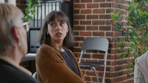 a person listens to a therapist in a painkiller rehab program