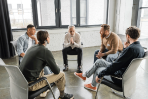 a group in a seroquel addiction treatment program listens to a therapist