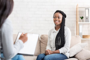 a person listens to a therapist talk about the benefits of family therapy