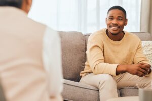a person listens to a therapist talk about the benefits of cognitive-behavioral therapy