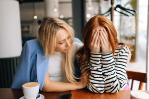 a person comforts another after recognizing signs of ptsd in their loved one