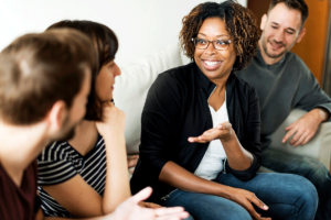 a group of people smile and talk after they were able to find a residential treatment program in washington